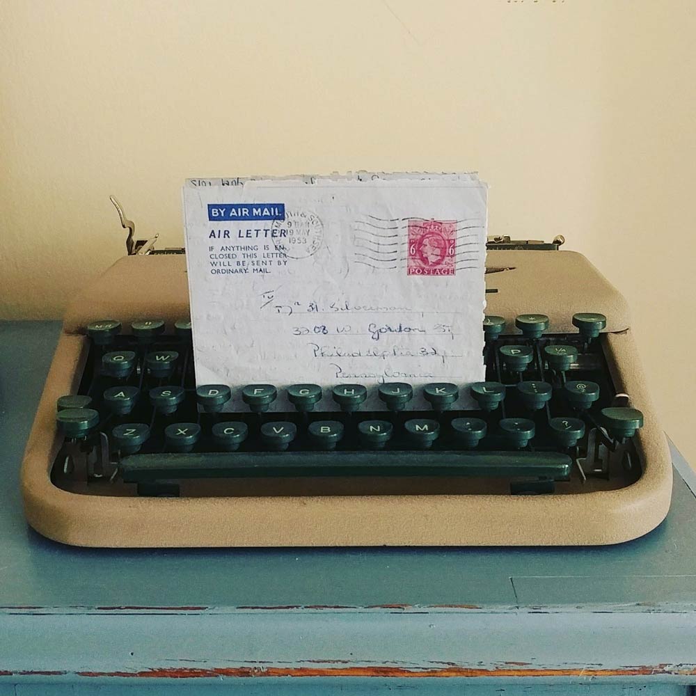 A letter held up by the keys in a typewriter