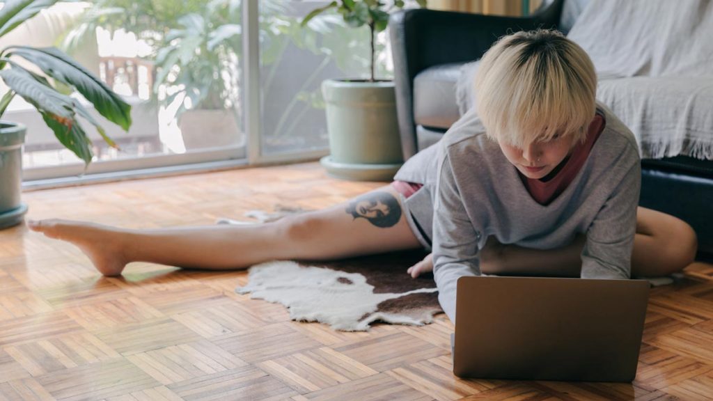 A woman relaxs on the floor and writes her pen pal a conversation starter